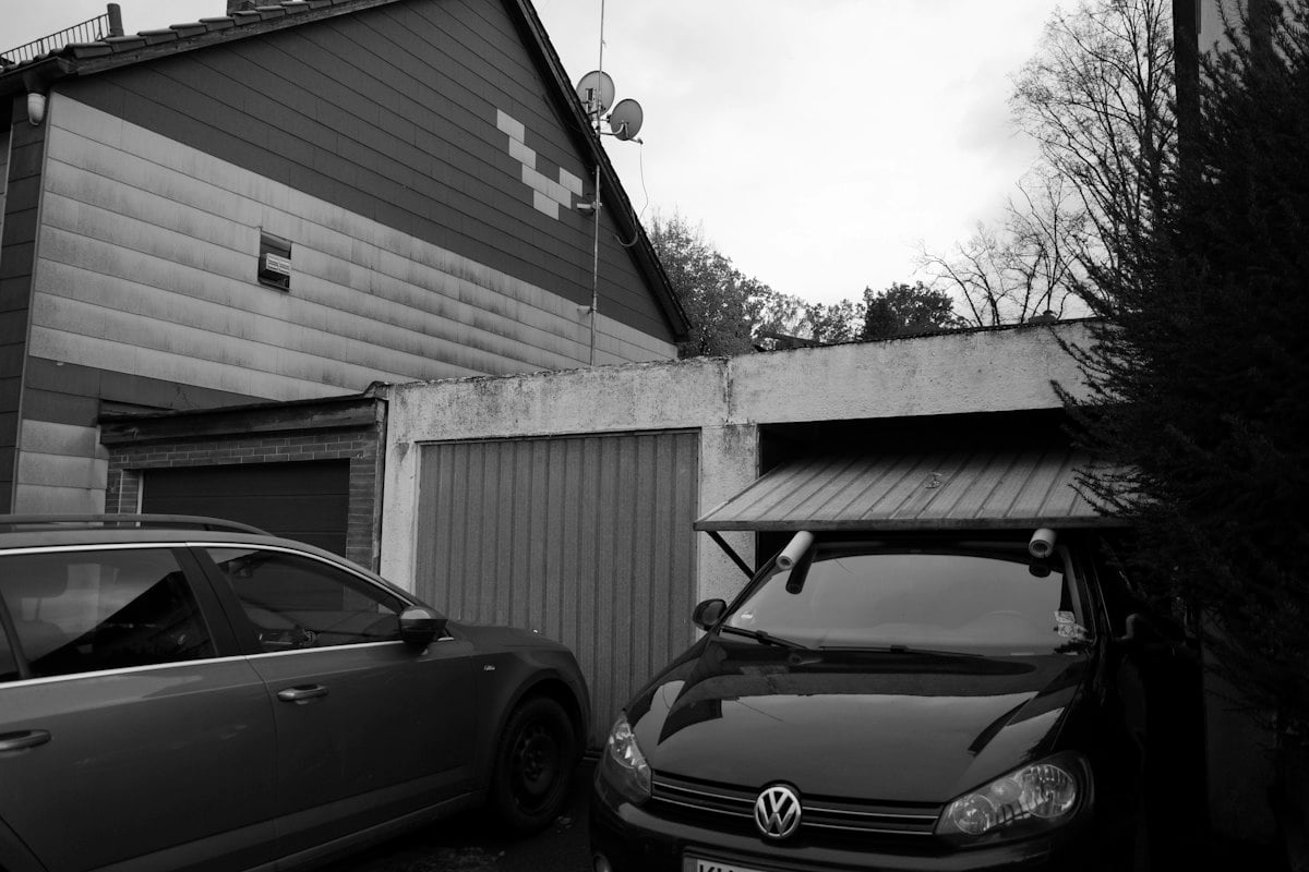 Cars parked in front of a row of garage doors