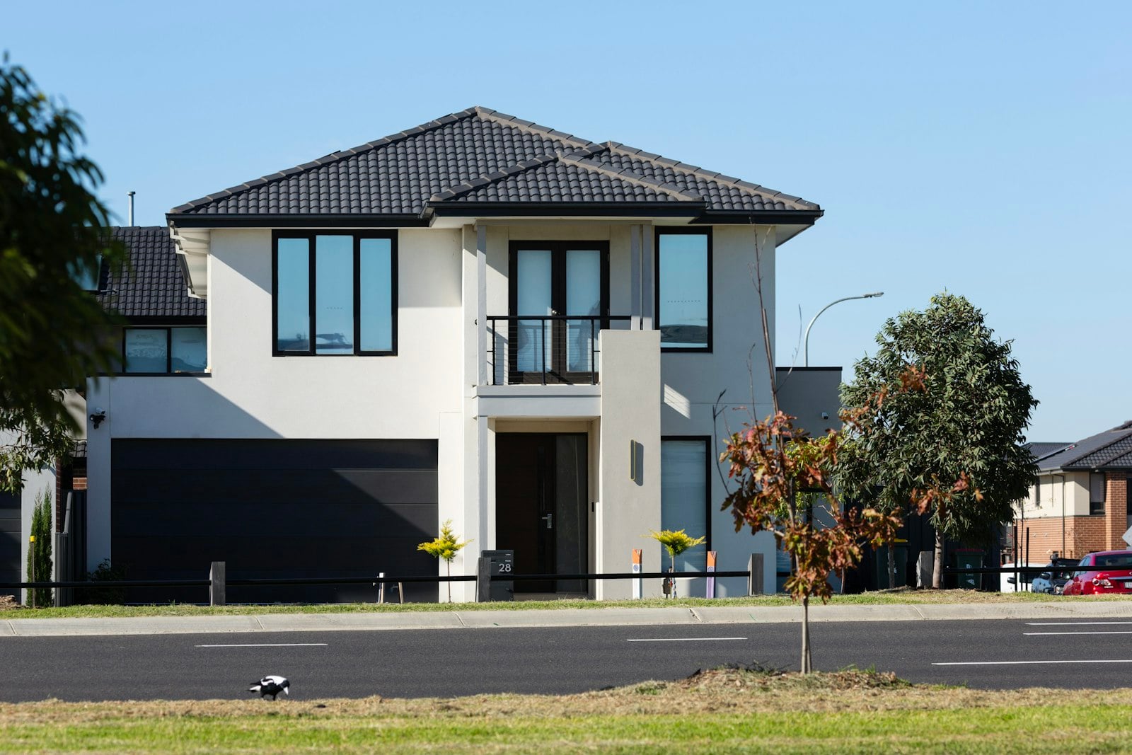 Two-story home with a dark double garage door